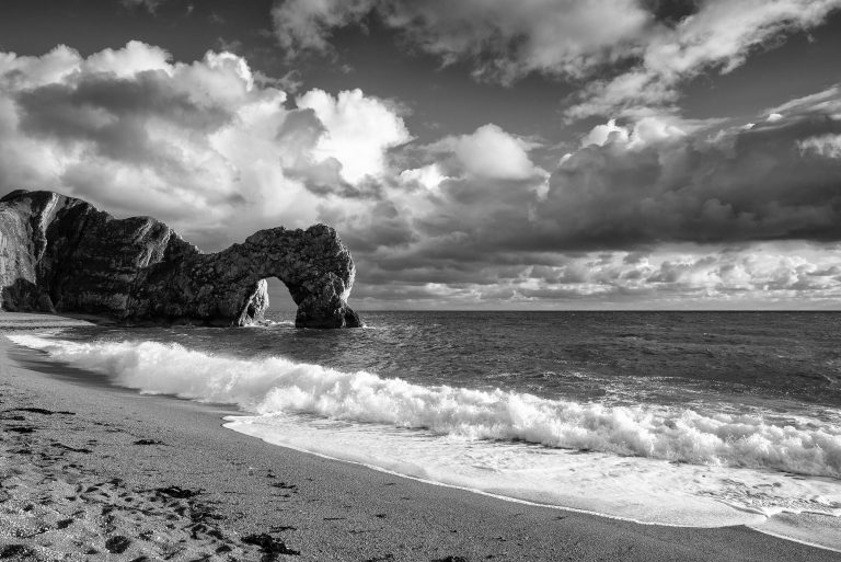 Monochrome capture of Durdle Door with dramatic clouds, Jurassic Coast, Dorset, England, UK