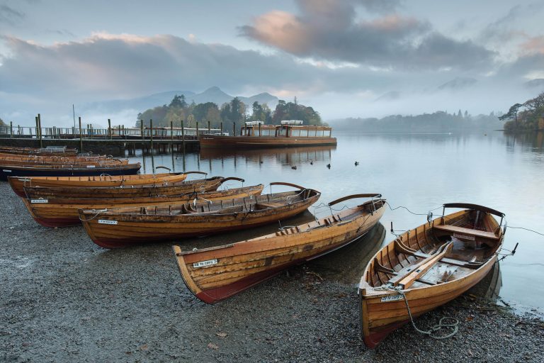 Sunrise over the rowing boats at Derwent Water in the Lake District, Cumbria, England, UK
