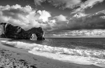 Monochrome capture of Durdle Door with dramatic clouds, Jurassic Coast, Dorset, England, UK